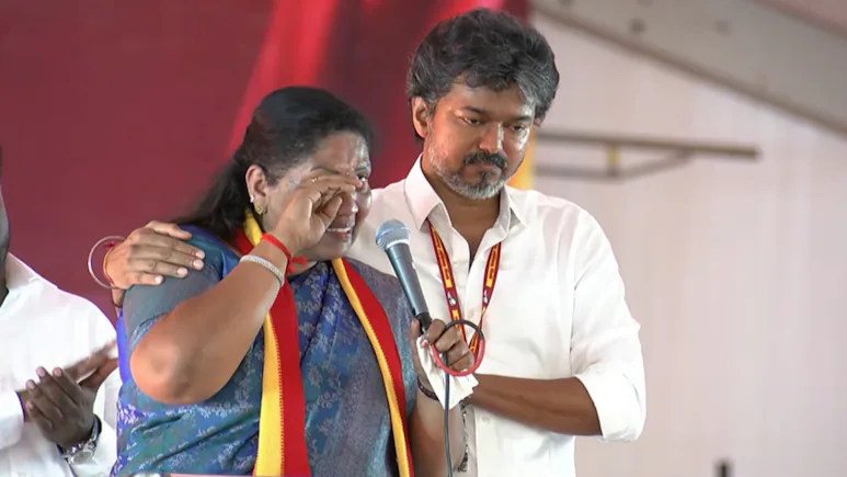Vijay, who was standing beside her on the stage, stepped forward to console the party leader as